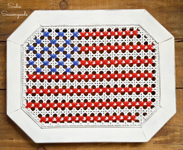Sadie_Seasongoods_broken_cane_table_repurposed_into_oversized_cross_stitch_American_flag_USA
