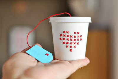 cross stitch on a paper cup