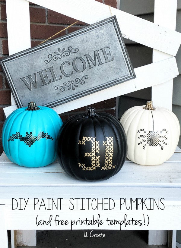 Painted pumpkins with cross stitch motifs.